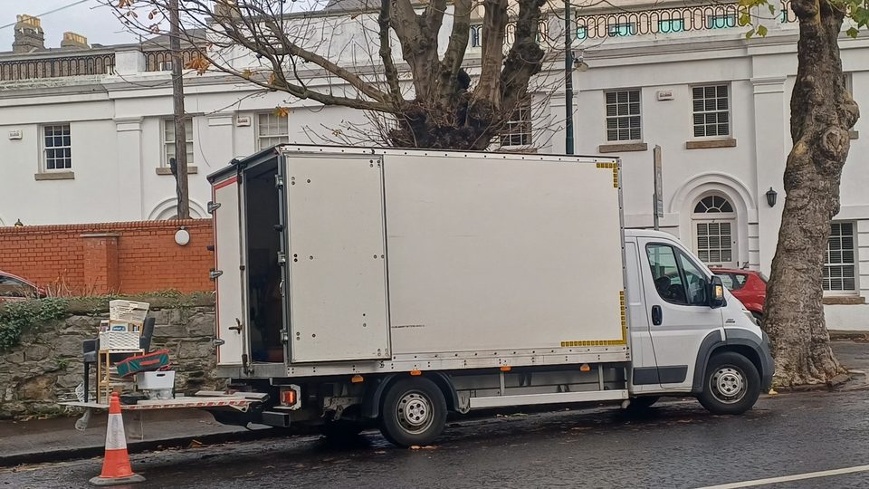 The Junk Removal box van on a Dublin street, tail-lift down and a load being cleared